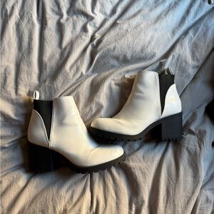 White ankle boots with black accents. Only flaw is on slide 3, little scuff mark